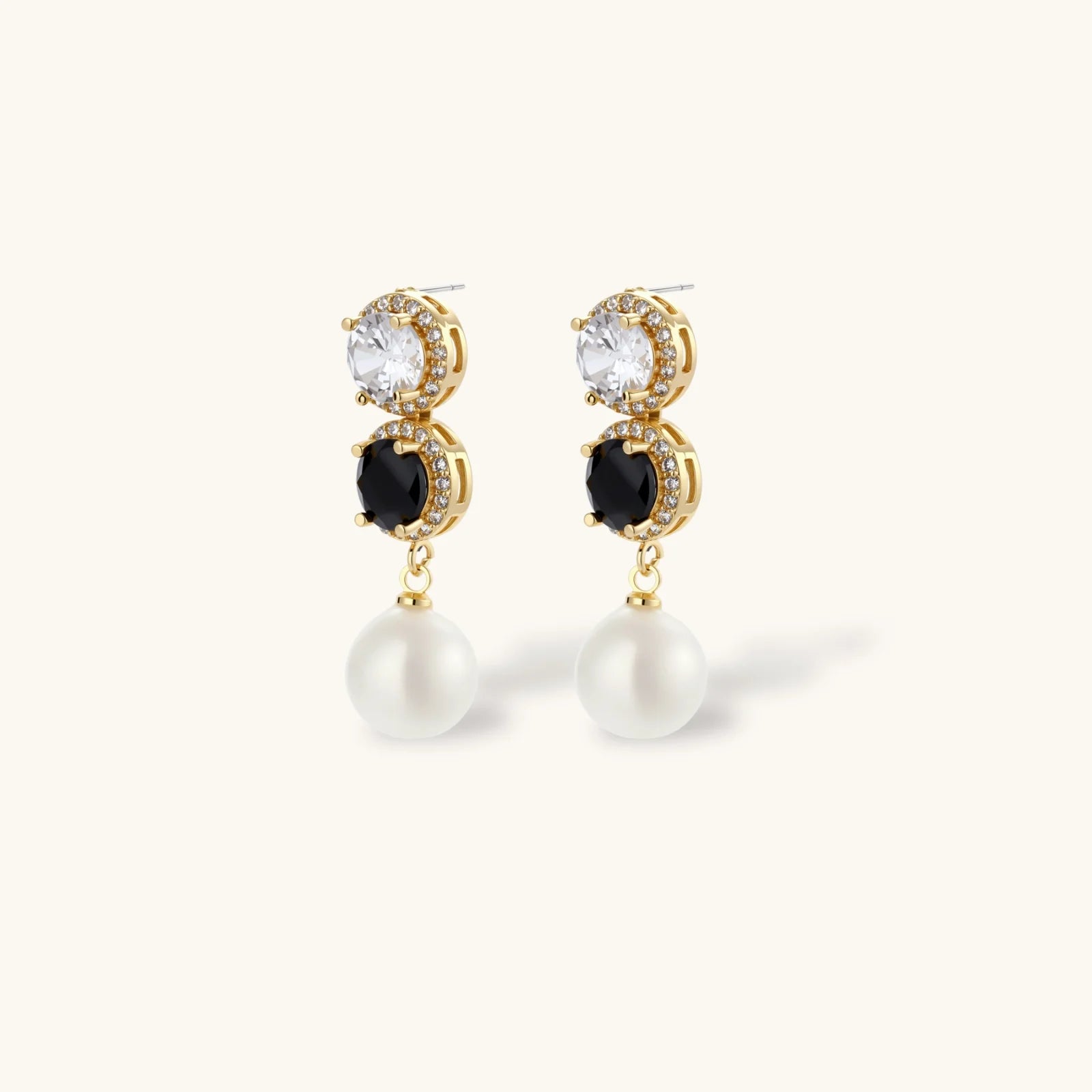 Gold-plated jewelry set with alternating black and clear cubic zirconia stones, featuring necklace, earrings and bracelet