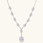 Elegant white gold plated jewelry set with oval cubic zirconia stones in halo settings, featuring Y-necklace and drop earrings.