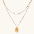 Layered paperclip chain necklace with organic flowing pendant made from eco-zinc alloy in warm gold finish