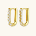 Close-up of small sterling silver huggie hoops completely covered in sparkling clear crystals with hinged closure