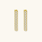 Close-up of small sterling silver huggie hoops completely covered in sparkling clear crystals with hinged closure