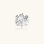 Wide band ring with sculptural wave ripples in polished white gold plated eco-brass on cream background