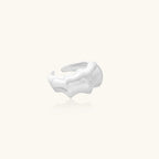 Brushed sterling silver ring with organic wave-like edges and adjustable cuff design on white background