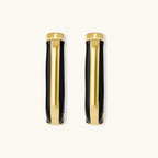 Modern hoop earrings with gold-plated and black sections, featuring hinged closure on white background.