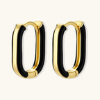 Modern hoop earrings with gold-plated and black sections, featuring hinged closure on white background.